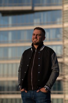 Portrait of a smiling bearded man outdoors at sunset