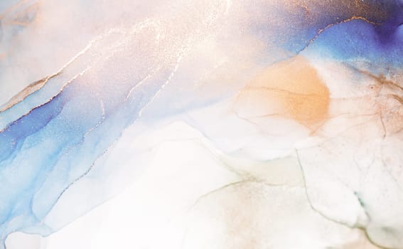 A close-up shot of abstract ink swirls in blue, gold, and peach colors. The colors blend and create a dynamic and ethereal effect.