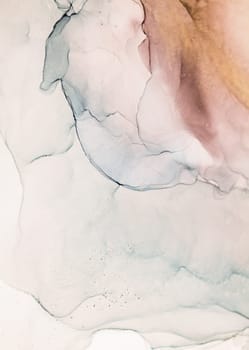 A close-up image of abstract ink swirls in earthy tones of brown, grey, and white. The ink is flowing and mixing, creating a dynamic and artistic composition.