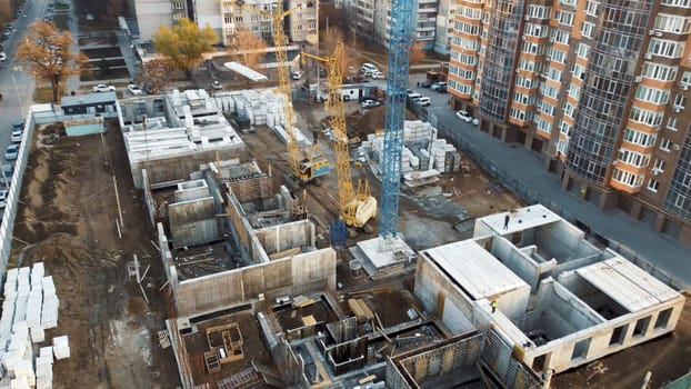 The surrounding area is a mix of completed high-rise buildings and vacant lots.