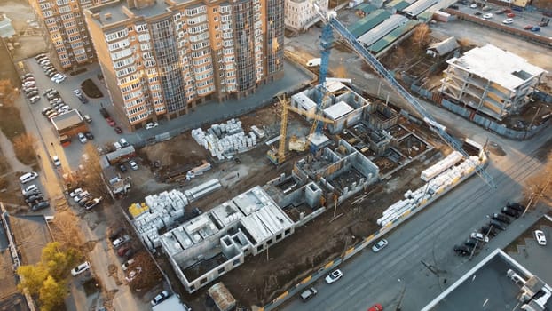 An urban design landscape featuring a skyscraper tower under construction in the city, showcasing a modern facade and roof of the condominium building