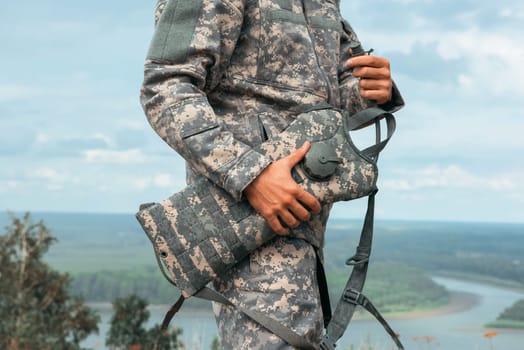 Man tourist standing in military outfit outdoor. Travel or military concept