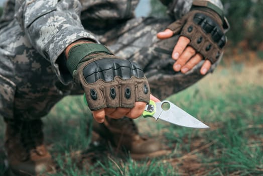 A man with a knife in the forest. Travel or military concept