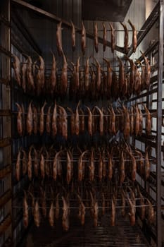 Smoked fish production concept: smoked fish in smokehouse box.