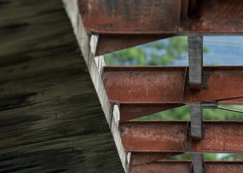 Closeup view of a Old concrete structure with Steel beams an Old warehouse. Space for text, Selective focus.