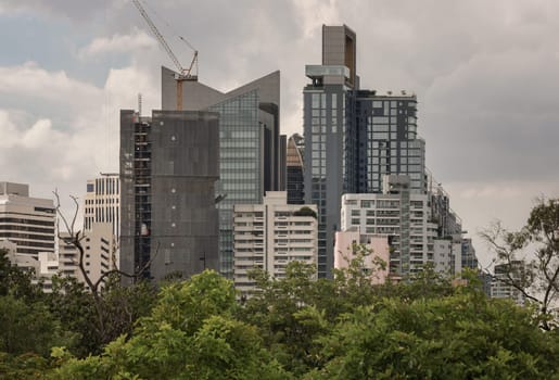 Bangkok, Thailand - 22 Jun, 2024 - Architecture exterior of Modern high-rise buildings on sky background. Picturesque view of skyscrapers and green spaces, Space for text, Selective focus.