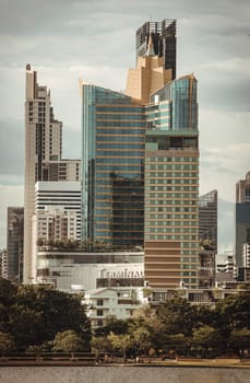 Bangkok, Thailand - 22 Jun, 2024 - Cityscape office buildings with modern architecture. Picturesque view of skyscrapers and dramatic sky before sunset, Copy space, Selective focus.