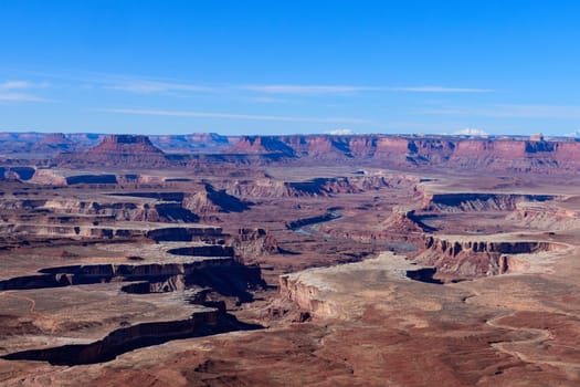 Stunning aerial view from the Green River Overlook in Canyonlands National Park, Utah. This awe-inspiring landscape showcases deep canyons and vast plateaus under a clear blue sky - USA