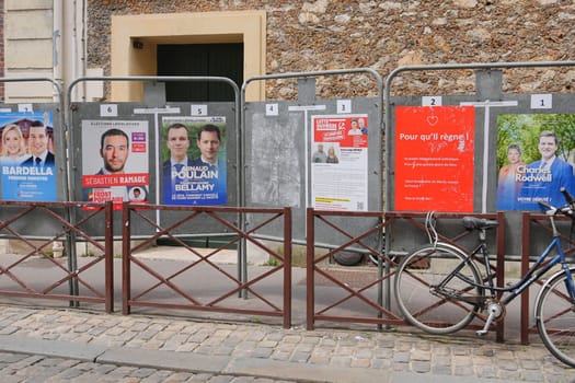 VERSAILLES, FRANCE - JUNE 26, 2024 : The banners with candidates for elections legislative