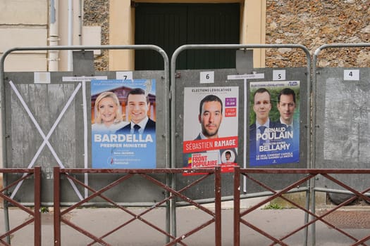 VERSAILLES, FRANCE - JUNE 26, 2024 : The banners with candidates for elections legislative