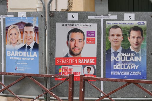 VERSAILLES, FRANCE - JUNE 26, 2024 : The banners with candidates for elections legislative