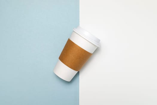 Paper Coffee or Tea Mug, Cup with White Lid and Corrugated Sleeve On White and Blue Background. Eco Hot Drinks Cup, Beverage, Horizontal Plane, Copy Space. On the Go Food Service Application.