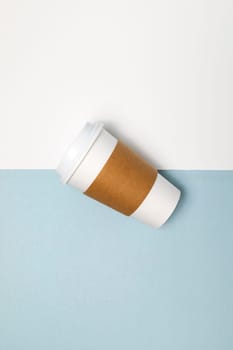 Paper Coffee or Tea Mug, Cup with White Lid and Corrugated Sleeve On White and Blue Background. Eco Hot Drinks Cup, Beverage, Vertical Plane, Copy Space. On the Go Food Service Application.