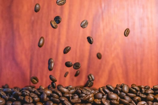 Roasted coffee beans flying in the air. Background for coffee.