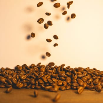 Roasted coffee beans flying in the air. Background for coffee.