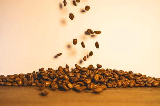Roasted coffee beans flying in the air. Background for coffee.