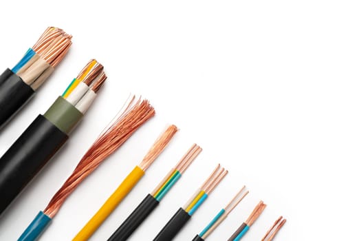 A close-up image showcasing various types of electrical wires with exposed copper strands on a white background.