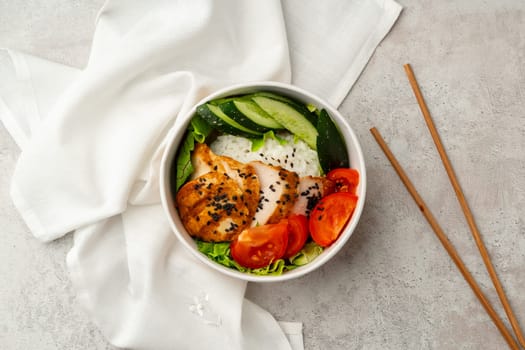 Tasty poke bowls on gray textured surface close up