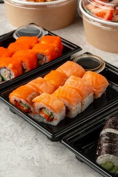 Close up photo of sushi rolls on gray table