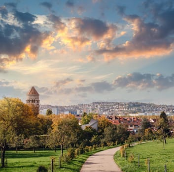 Germany, Stuttgart panorama view. Beautiful houses in autumn, Sky and nature landscape. Vineyards in Stuttgart - colorful wine growing region in the south of Germany with view over Neckar Valley. Germany, Stuttgart city panorama view above vineyards, industry, houses, streets, stadium and highway at sunset in warm orange light.