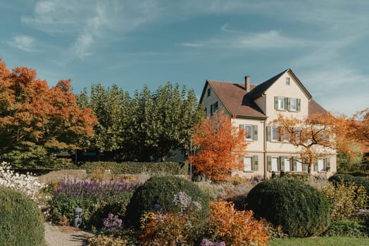 House with nice garden in fall. Flowers in the Park. Bietigheim-Bissingen. Germany, Europe. Autumn Park and house, nobody, bush and grenery