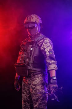 Soldier in gear holds drone against a red and blue smoky background, conveying intensity and military action