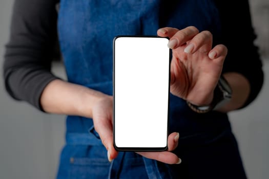 Woman In Stylish Forefront Shows Smartphone With White Screen In Close-Up View