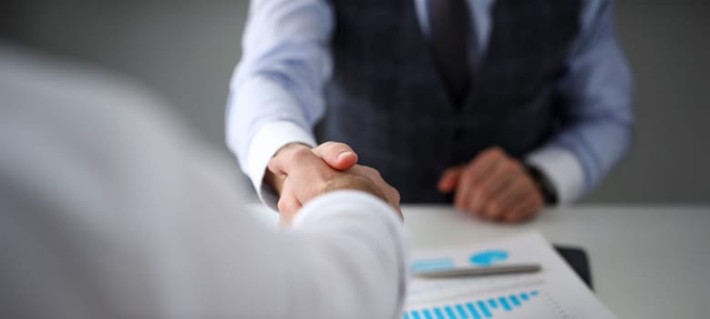 Man in suit and tie give hand as hello in office closeup. Friend welcome mediation offer positive introduction thanks gesture summit executive approval motivation male arm strike bargain