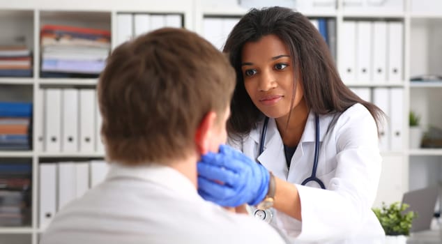 Beautiful black smiling female doctor talk with patient about his history list. Physical exam er anamnesis communication disease prevention ward round 911 prescribe remedy healthy lifestyle concept
