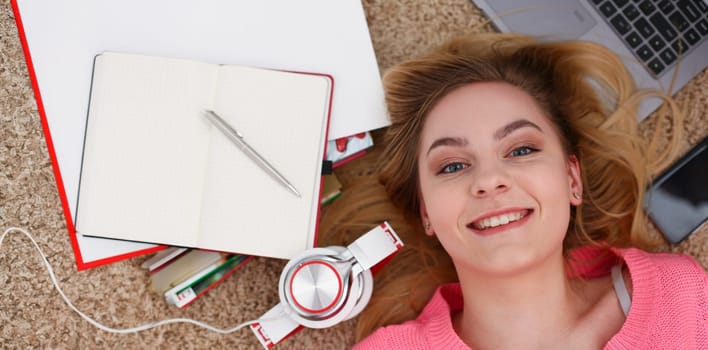 young beautiful woman lie on floor study hard have a lot of work is tired