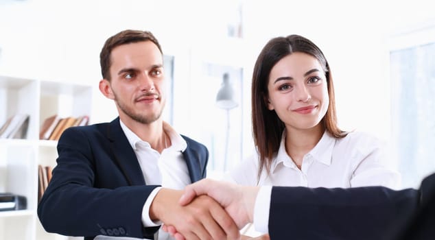 Smiling man in suit shake hands as hello in office portrait. Friend welcome mediation offer positive introduction greet or thanks gesture summit participate approval strike arm bargain concept
