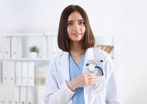 Beautiful smiling female doctor stand in office portrait. Physical and patient disease prevention exam er ward round 911 prescribe remedy healthy lifestyle consultant nurse profession concept
