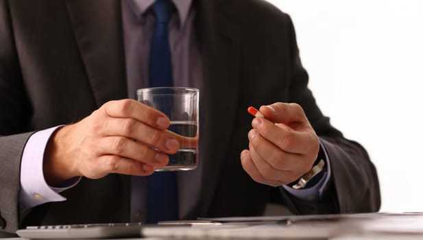 Adult male businessman hold tablet on glass water. On January 1 after celebrating the new year came to work while intoxicated closeup concept