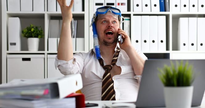 Man wearing suit and tie in goggles and snorkel talk cellphone at office workplace ready to take off portrait. Count days to leave annual day off workaholic freedom fun tourism resort idea concept