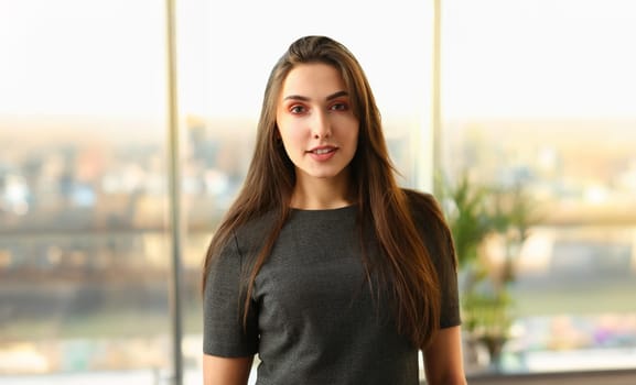 Beautiful european woman portrait. Worth office background and smiling beauty fashion style curly hair with white strands view of the eye in the camera