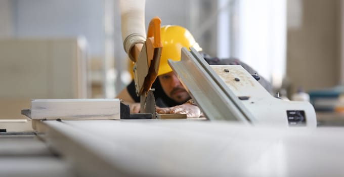 Worker using electric saw portrait. Manual job workplace DIY inspiration improvement fix shop yellow helmet hard hat joinery startup idea industrial education profession career concept
