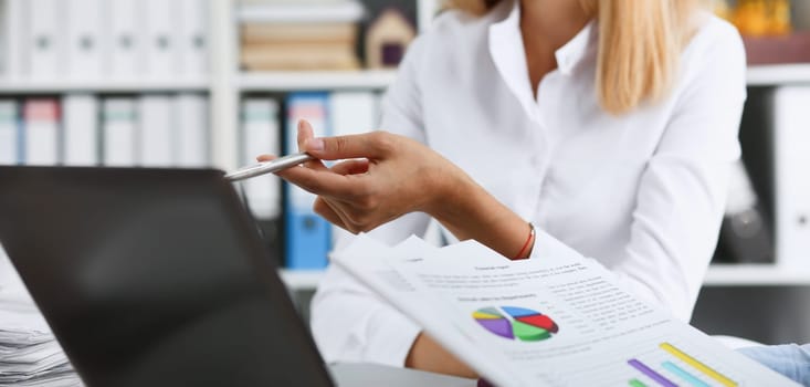 Group of people deliberate on white laptop problem in office portrait. Graph consult idea participate creative talk review situation job client document explain train successful decision concept