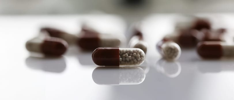 Tablets scattered on the table of the pharmaceutical laboratory pill for the prescription and treatment of various diseases chemistry