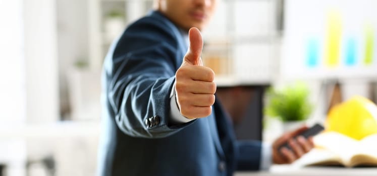 Male arm show OK or confirm during conference in office closeup. High level and quality product offer okay symbol expression perfect mediation solution happy client creative adviser participate