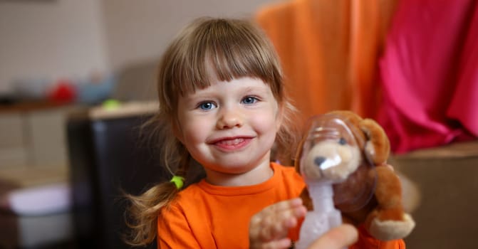 Happy child makes inhalation at home for cough health