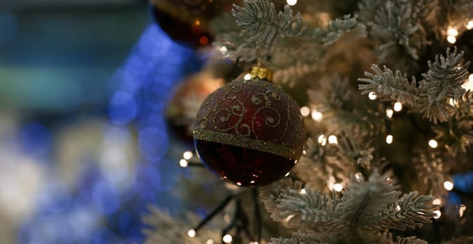 Red ball hanging on the christmas tree background