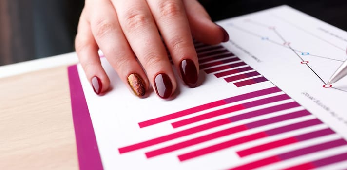 Female arm hold and point silver pen in financial graph solve and discuss problem closeup. Fresh view at situation board council sale adviser examine advisor profit audit job market irs inspector