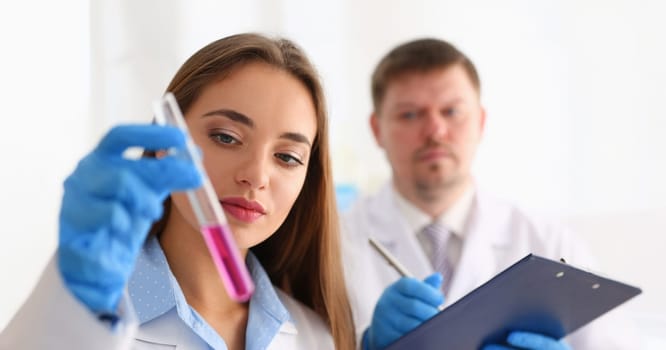 Technician hold in arms in protective gloves sample bottle with poison fluid portrait. Medical worker in uniform use reagent tube for virus infection exam water biological toxic reaction drug creation
