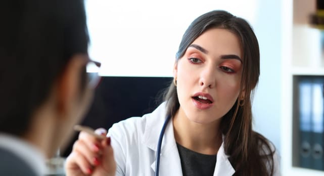 Beautiful smiling female doctor talk with patient about his history list. Physical exam er anamnesis communication disease prevention ward round 911 prescribe remedy healthy lifestyle concept