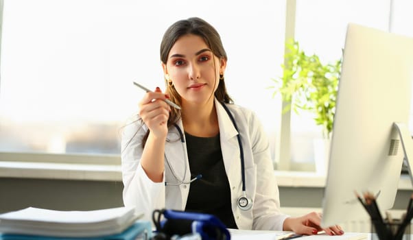 Beautiful smiling female doctor at workplace portrait. Physical and disease prevention patient aid exam visit 911 ward round prescribe remedy healthy lifestyle consultant profession concept