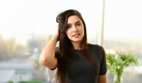 Beautiful european woman portrait. Worth office background and smiling beauty fashion style curly hair with white strands view of the eye in the camera