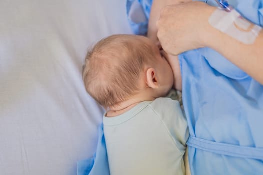 A mom breastfeeds her newborn baby in the hospital. The intimate moment fosters bonding between mother and child, promoting emotional connection and providing essential nourishment for the baby's well-being.