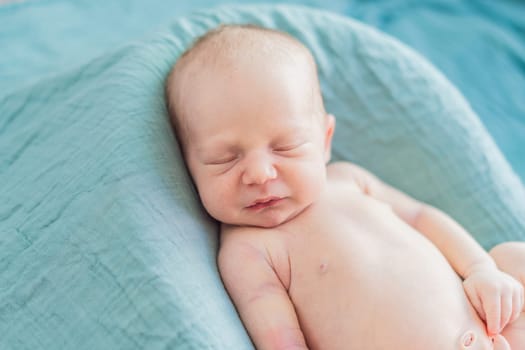 The baby is sleeping peacefully in his cozy nest. Newborn photo session captures the serene innocence and warmth of early moments.