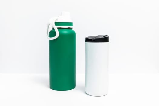 Isolated Reusable Sport Green and Water Bottles, Protein Shaker On White Background. Tumbler, Product Template. Travel Mug Horizontal Plane. High quality photo