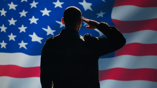 American soldier doing saluting hand gesture towards USA flag in command center, showing respect. Military unit in uniform serving in United States Armed Forces, doing patriotic gesturing, camera A